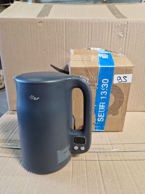 a blue kettle sitting on top of a cardboard box
