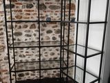 a close up of a book shelf with a brick wall in the background