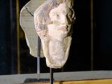 a statue of a head on a stand in a room