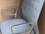 a blue office chair sitting in a cardboard box