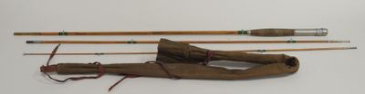 three fishing rods and a fishing pole on a white surface