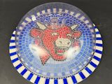 a blue and white plate with a picture of a skull on it