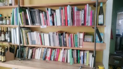 a book shelf with many books on it in a room