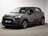 La Citroën grise est garée dans un garage au sol carrelé