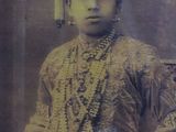 an old photo of a young boy in a traditional dress