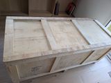 a large wooden box sitting on top of a hard wood floor