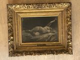 a painting of a nude laying on a bed in a gold frame