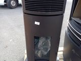 a black air conditioner sitting on a pallet next to a white van