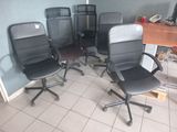 four office chairs in a room with a desk and a chair