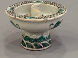 a white bowl with a green and white design on it