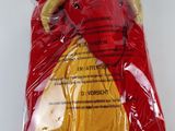 a red and yellow stuffed animal in a plastic bag