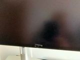 a flat screen tv sitting on top of a white table