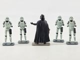 star wars figurines are lined up in a row on a white surface