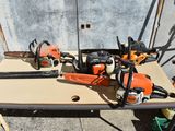 several chainsaws are sitting on a table next to a wall