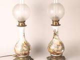 pair of antique glass lamps with gold and white designs on them