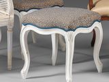 two chairs and a foot stool are sitting next to each other