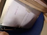 a person holding a piece of paper that is in a suitcase