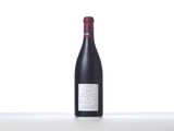 a bottle of red wine sitting on top of a table