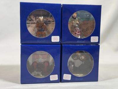 three boxed boxes of christmas ornaments of a dog and a cat