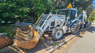 a tractor that is parked on the side of the road