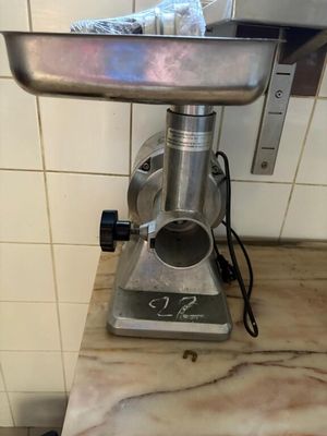 a meat grinder sitting on a counter in a kitchen