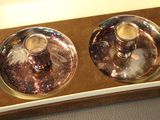 two candles that are sitting in a box on the table