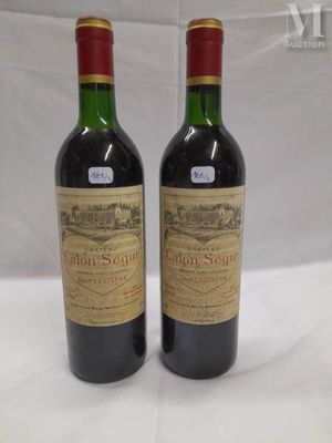 two bottles of wine sitting on top of a white table