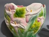 two vases that have flowers on them on a table
