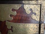 a large wooden chest with brass decorations on it