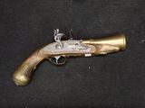 an old gun that is on display on a black surface