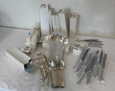a lot of silver spoons and forks on the table