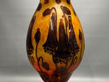 a vase that is sitting on a stand on a table