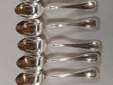 many spoons that are sitting on a table