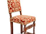 une image représentant une chaise en bois dont l'assise est recouverte d'un tissu rouge et or