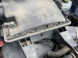 a close up of a car engine with the hood open