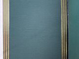 an open book with a green cover sitting on a white surface