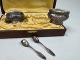 two spoons and a bowl in a box on a table