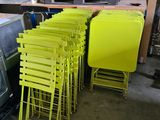 a lot of yellow chairs and a television in a room