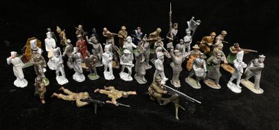 many figurines of soldiers on a black background