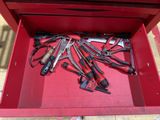 many tools in a red tool box on the floor