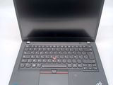 the laptop is open on a white surface with a black keyboard