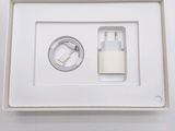 a white box with a charger and a cable in it