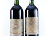 two bottles of wine sitting next to each other on a white surface