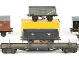 five toy trains that are lined up on a white surface