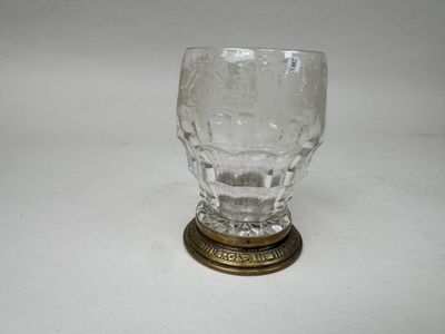 a glass cup that is sitting on top of a table