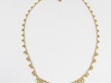 a gold necklace with coins on a chain