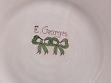 a white plate with a design on it that says el georges