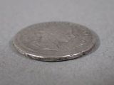 a silver coin sitting on top of a table