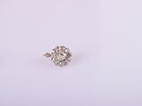 a close up of a pair of diamond earrings on a white surface
