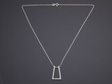 un collier en argent avec un pendentif de forme carrée monté sur une chaîne